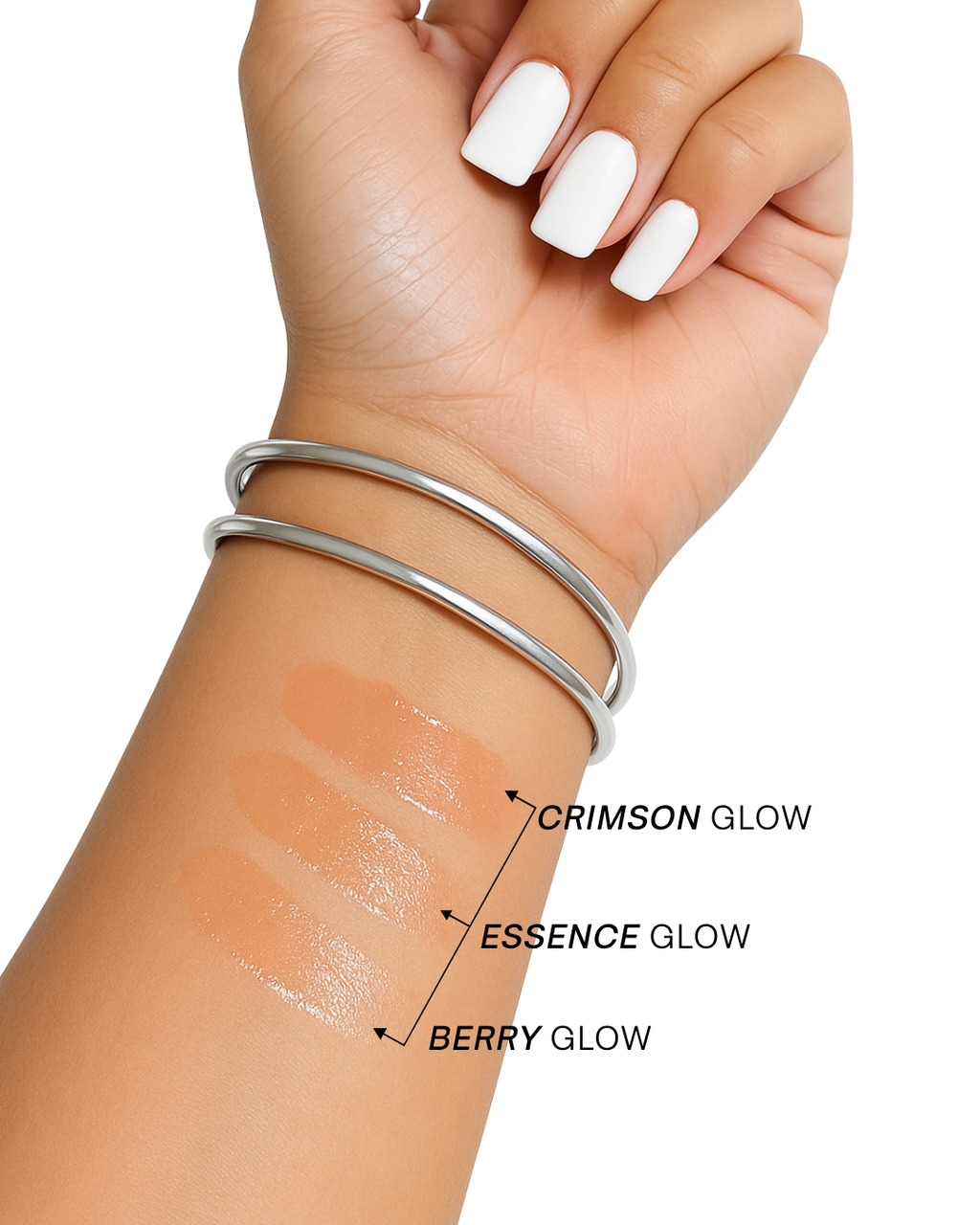 Hand with wrist swatches of different lip glaze gloss colors labeled 'Crimson Glow', 'Essence Glow', and 'Berry Glow' on a white background.