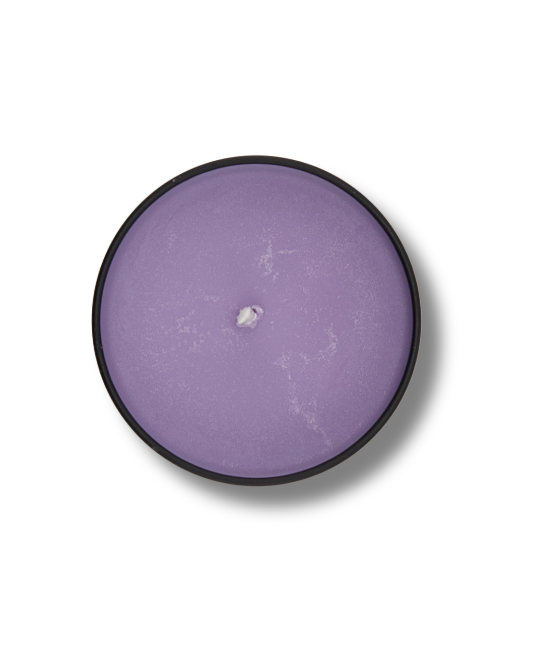 Round purple lavender chamomile candle with black rim on a white background